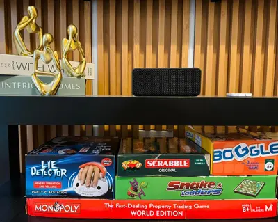 a shelf with cookies and trophies on it at K&K The Modern Crib at Holland Park Condo Southwoods City in Biñan