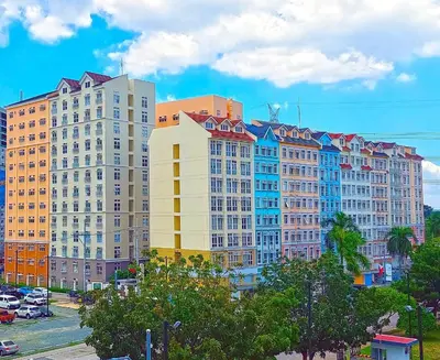 a group of tall buildings in a city at K&K The Modern Crib at Holland Park Condo Southwoods City in Biñan