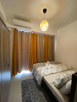 a bedroom with two beds and a large window at D'Shore to Relax Shore Residences MOA PASAY in Manila