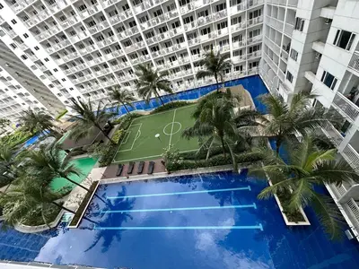 an overhead view of a large apartment building with a tennis court at D'Shore to Relax Shore Residences MOA PASAY in Manila