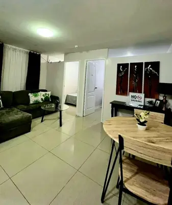 a living room with a couch and a table at Gorgeous 2BR Condo unit with free WiFi in Imus