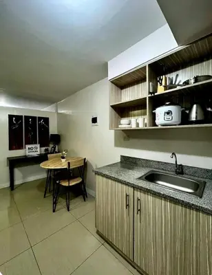a kitchen with a sink and a table in it at Gorgeous 2BR Condo unit with free WiFi in Imus