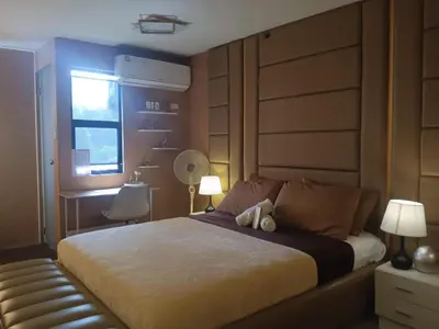 a bedroom with a bed with two lamps and a window at The Barracks Staycation in Santa Rosa