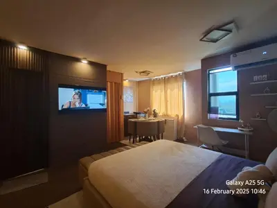 a hotel room with a bed and a television at The Barracks Staycation in Santa Rosa