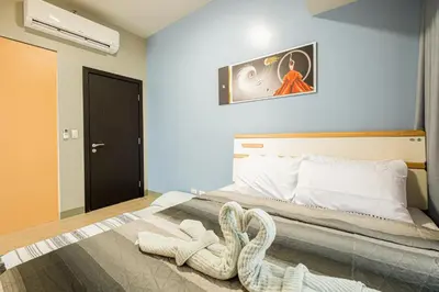 a bedroom with a bed with a snake on it at BGC 2BR Uptown Parksuites with balcony and bathtub in Manila