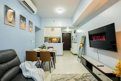 a living room with a couch and a dining room at BGC 2BR Uptown Parksuites with balcony and bathtub in Manila