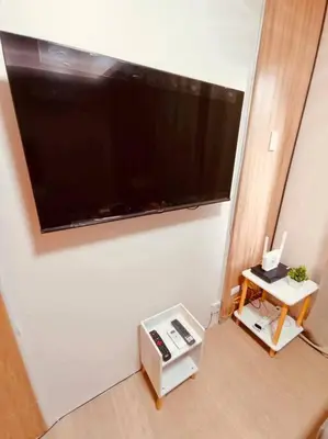 a living room with a large flat screen tv on the wall at Serenity in Style: Scandinavian Zen in Nuvali in Pitland