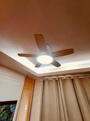 a ceiling fan with a light in a room at Serenity in Style: Scandinavian Zen in Nuvali in Pitland
