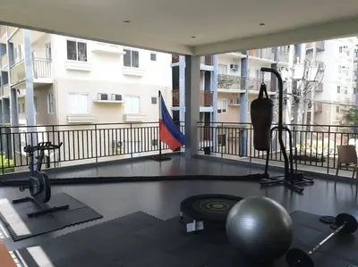 a room with a gym with a ball and a exercise ball at Serenity in Style: Scandinavian Zen in Nuvali in Pitland