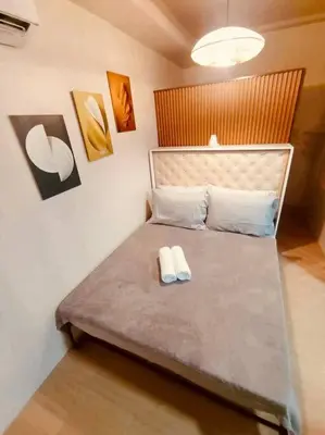 a bedroom with a bed with two towels on it at Serenity in Style: Scandinavian Zen in Nuvali in Pitland