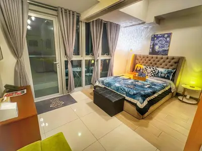 a bedroom with a bed and a large window at EG Private House -BGC UPTOWN in Manila