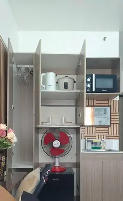 a small kitchen with a red fan in a room at JJMC HOMESTAY 32 With Netflix and Unli Wifi in Manila