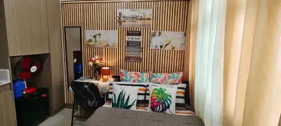 a room with a bed and a table with pillows at JJMC HOMESTAY 32 With Netflix and Unli Wifi in Manila