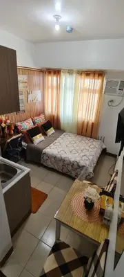 a living room with a bed and a kitchen at JJMC HOMESTAY 32 With Netflix and Unli Wifi in Manila