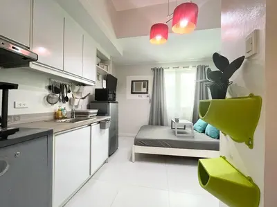 a small kitchen with a bed in the middle of it at KL Tower Studio Near Greenbelt Makati in Manila