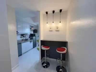 a kitchen with two stools and a counter in a room at KL Tower Studio Near Greenbelt Makati in Manila