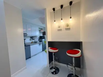 a kitchen with two red stools in a room at KL Tower Studio Near Greenbelt Makati in Manila