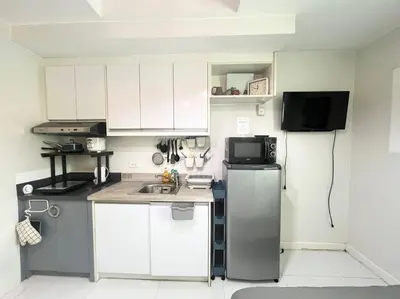 a small kitchen with a refrigerator and a microwave at KL Tower Studio Near Greenbelt Makati in Manila