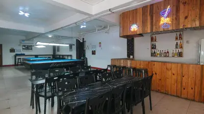 a room with black chairs and tables in a restaurant at RedDoorz @ Western Bicutan Transients Inn in Manila
