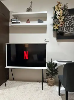 a flat screen tv sitting in a living room at My Hideaway@Air in Manila