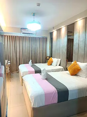 a hotel room with two beds in a room at New York Suite - by GUEST RESERVATION'S MANILA in Manila