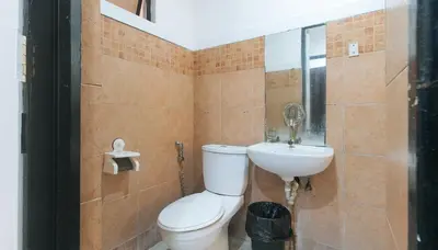 a bathroom with a toilet and a sink at RedDoorz @ Moss Hotel Dasmarinas in Cavite