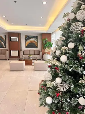 a christmas tree in the lobby of a hotel at SMDC Green 2 Staycation, The Traditional & Modern Fusion Condo in Pasong Bayog