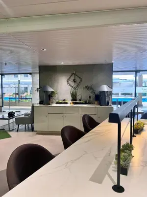 a lobby with a long table and chairs and windows at SMDC Green 2 Staycation, The Traditional & Modern Fusion Condo in Pasong Bayog