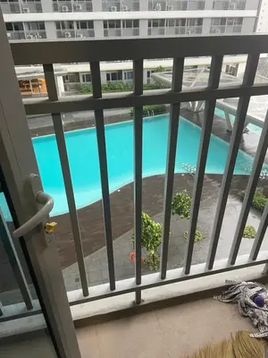 a view of a swimming pool from a balcony at Fame Residences Pool View near MRT, Shaw, Megamall & Ortigas 1026 in Manila