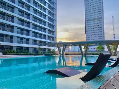 a swimming pool in the middle of a building at Fame Residences Pool View near MRT, Shaw, Megamall & Ortigas 1026 in Manila