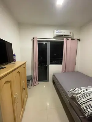 a small bedroom with a bed and a television at Fame Residences Pool View near MRT, Shaw, Megamall & Ortigas 1026 in Manila