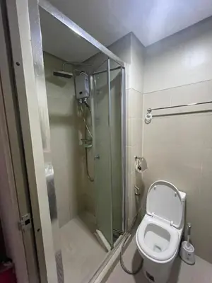 a bathroom with a shower and a toilet at Fame Residences 1 bedroom near MRT, Shaw, Megamall, Shangrila, Ortigas 1401 in Manila