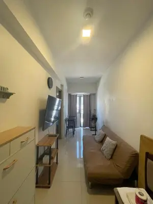 a living room with a couch and a table at Fame Residences 1 bedroom near MRT, Shaw, Megamall, Shangrila, Ortigas 1401 in Manila