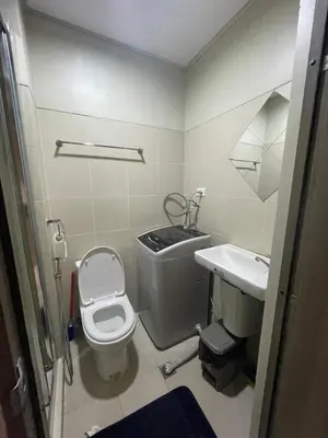 a small bathroom with a toilet and a sink at Fame Residences 1 bedroom near MRT, Shaw, Megamall, Shangrila, Ortigas 1401 in Manila