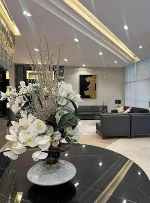 a lobby with a vase of flowers on a table at Fame Residences 1 bedroom near MRT, Shaw, Megamall, Shangrila, Ortigas 1401 in Manila
