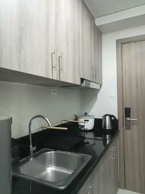 a kitchen with a sink and a counter top at Free Wi-Fi Luxurious Haven by the Bay - 2BR Near MOA PICC CCP in Manila