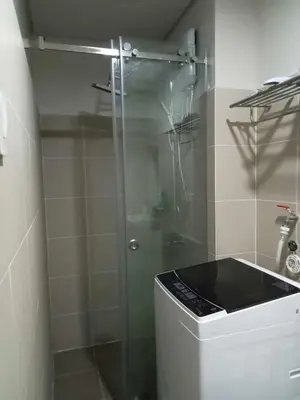 a bathroom with a glass shower with a toilet at Free Wi-Fi Luxurious Haven by the Bay - 2BR Near MOA PICC CCP in Manila