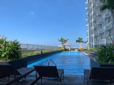 a swimming pool in the middle of a building at Free Wi-Fi Luxurious Haven by the Bay - 2BR Near MOA PICC CCP in Manila