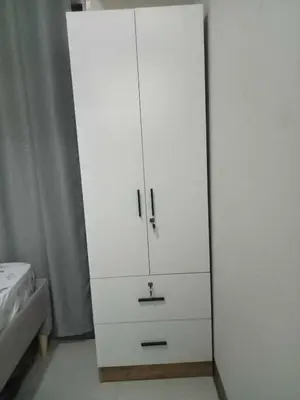 a white cabinet in a bedroom next to a bed at Free Wi-Fi Luxurious Haven by the Bay - 2BR Near MOA PICC CCP in Manila