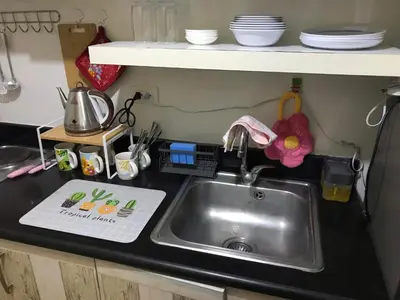 a kitchen counter with a sink in a kitchen at 5 minutes to Jazz Mall! Studio-type condo 100mbps in Manila