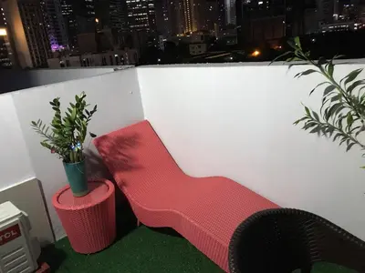 a red chair and a potted plant on a balcony at 5 minutes to Jazz Mall! Studio-type condo 100mbps in Manila