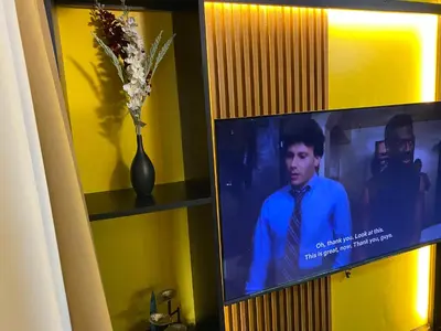 a television with a vase of flowers on a wall at Laugh and Lounge 2 Bedroom Luxury Condo Air residence Makati in Manila