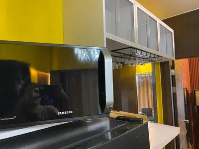a person taking a picture of a microwave in a kitchen at Laugh and Lounge 2 Bedroom Luxury Condo Air residence Makati in Manila