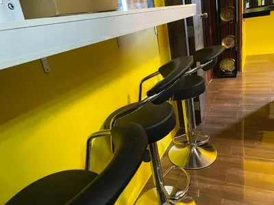 a row of chairs lined up against a yellow wall at Laugh and Lounge 2 Bedroom Luxury Condo Air residence Makati in Manila