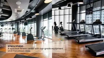 a gym with treadmills and ellipticals in a room with windows at Azure skyview 1BR netflix karaoke ps3 Airport in Manila