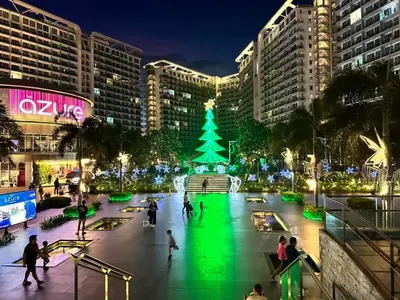 a christmas tree in the middle of a city at night at Azure skyview 1BR netflix karaoke ps3 Airport in Manila