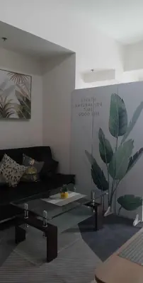 a living room with a couch and a table at Cookies Nest at 100West Makati in Manila