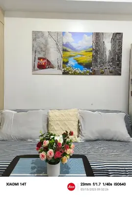 a bedroom with a bed with a vase of flowers on it at Condo UNIT-SM JAZZ RESIDENCES in Manila