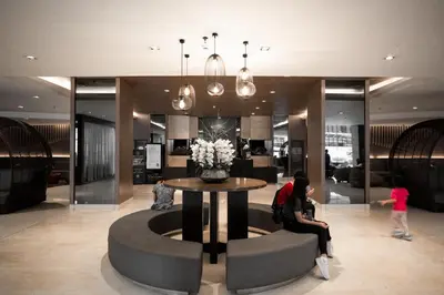 a woman sitting at a table in a lobby at Shore Residences Tower C, Pasay near SM MOA, please text or call us ASAP once booked for the guest authorization form in Manila