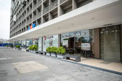 a store front of a building with potted plants at Shore Residences Tower C, Pasay near SM MOA, please text or call us ASAP once booked for the guest authorization form in Manila